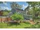 Two-story home with a well-maintained lawn, patio, sunroom, and fenced yard, showcasing its outdoor living spaces at 11700 Fernhurst Ln, Charlotte, NC 28277