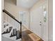 Inviting foyer features tile floors, stairs with dark wood trim, and ample natural light from the front door at 11700 Fernhurst Ln, Charlotte, NC 28277