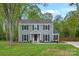 Charming two-story home with gray siding, black shutters, and a well-manicured lawn at 11700 Fernhurst Ln, Charlotte, NC 28277
