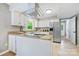 Bright, updated kitchen with white cabinets, granite countertops, stainless steel appliances, and a tiled floor at 11700 Fernhurst Ln, Charlotte, NC 28277
