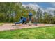 Community playground with slide, swings, and climbing structures surrounded by green space at 11700 Fernhurst Ln, Charlotte, NC 28277