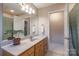 Bathroom vanity with marble countertop, wood cabinets, and well-lit mirror at 121 Shagbark Ln, Mooresville, NC 28115