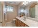 Upstairs bathroom with vanity, decorative mirror, and a window with floral valance at 121 Shagbark Ln, Mooresville, NC 28115
