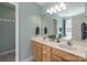Well-lit bathroom with a double sink vanity, marble countertop, and large mirror at 121 Shagbark Ln, Mooresville, NC 28115