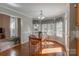 Sun-filled dining area features hardwood floors, three windows, and a classic chandelier at 121 Shagbark Ln, Mooresville, NC 28115