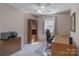 Home office featuring a wooden desk and cabinets, with a view to the outside at 121 Shagbark Ln, Mooresville, NC 28115