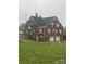 Exterior of a red brick building with white trim and several windows and doors with a grassy field in front at 1214 Pee Dee Ave, Albemarle, NC 28001
