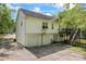 Rear view of house features a two-car garage, deck and stairway, with a spacious driveway at 12822 Diamond Dr, Pineville, NC 28134