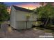 Rear view of house features a two-car garage, deck and stairway, with a spacious driveway at 12822 Diamond Dr, Pineville, NC 28134