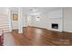 Finished basement featuring a brick fireplace, hardwood floors, and neutral paint at 12822 Diamond Dr, Pineville, NC 28134
