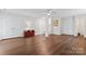 Open basement with hardwood floors, a ceiling fan and multiple doors at 12822 Diamond Dr, Pineville, NC 28134