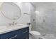 Modern bathroom featuring a marble shower, updated vanity with sink and faucet at 12822 Diamond Dr, Pineville, NC 28134