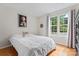 Cozy bedroom with a large window providing natural light, complemented by hardwood floors at 12822 Diamond Dr, Pineville, NC 28134