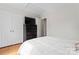 Neutral bedroom featuring wood floors, closet doors, and a chest of drawers with TV at 12822 Diamond Dr, Pineville, NC 28134