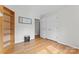Open bedroom with hardwood floors, closet, and a large window providing plenty of light at 12822 Diamond Dr, Pineville, NC 28134