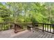 Wooden deck surrounded by lush trees at 12822 Diamond Dr, Pineville, NC 28134