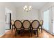 Dining room with a table and eight chairs and hardwood floors at 12822 Diamond Dr, Pineville, NC 28134
