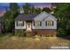 Charming two-story home with brick accents, black shutters, and inviting landscaped front yard at 12822 Diamond Dr, Pineville, NC 28134