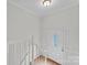 Hallway with white trim and hardwood floors leading to an ornate front door with leaded glass at 12822 Diamond Dr, Pineville, NC 28134