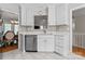 Kitchen view with stainless steel dishwasher, sink and adjacent dining area at 12822 Diamond Dr, Pineville, NC 28134