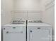 Functional laundry area showcasing a modern, front-loading washer and dryer set at 12822 Diamond Dr, Pineville, NC 28134