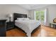 Bedroom with hardwood floors and large window at 12822 Diamond Dr, Pineville, NC 28134