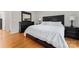 Bedroom featuring hardwood floors, a large bed and decorative lamps at 12822 Diamond Dr, Pineville, NC 28134
