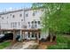Back exterior view of the home with a deck, patio, green lawn, and beautiful landscaping at 12905 Bullock Greenway Blvd, Charlotte, NC 28277