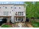 Back exterior view of the home with a deck, patio, green lawn, and beautiful landscaping at 12905 Bullock Greenway Blvd, Charlotte, NC 28277