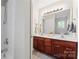 Bright bathroom featuring a double sink vanity and shower with white walls at 12905 Bullock Greenway Blvd, Charlotte, NC 28277