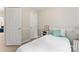 Simple bedroom with a twin bed, side table, and white trim and doors at 12905 Bullock Greenway Blvd, Charlotte, NC 28277