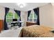 Bedroom featuring a desk, dresser, and large windows with natural light and blue curtains at 12905 Bullock Greenway Blvd, Charlotte, NC 28277