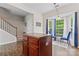 Bright breakfast nook featuring a bay window, adjacent to kitchen island, and view of stairway at 12905 Bullock Greenway Blvd, Charlotte, NC 28277
