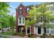 Two-story brick townhome with a bay window, a black front door and neatly landscaped front yard at 12905 Bullock Greenway Blvd, Charlotte, NC 28277