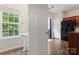 View from hallway showing bright powder room and sightlines to the kitchen and breakfast nook at 12905 Bullock Greenway Blvd, Charlotte, NC 28277