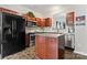 Well-equipped kitchen with stainless steel appliances, central island, and dark wood cabinetry at 12905 Bullock Greenway Blvd, Charlotte, NC 28277