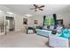 Open living room featuring neutral color scheme, a ceiling fan, and connection to dining area at 12905 Bullock Greenway Blvd, Charlotte, NC 28277