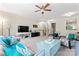 Bright living room with ceiling fan, with plush seating, and a stairway in the background at 12905 Bullock Greenway Blvd, Charlotte, NC 28277
