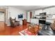 Open concept living space with white cabinets, hardwood floors, and comfortable seating at 12905 Bullock Greenway Blvd, Charlotte, NC 28277