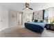 Spacious main bedroom featuring a ceiling fan, decorative wall art, and natural light at 12905 Bullock Greenway Blvd, Charlotte, NC 28277