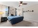 Large main bedroom showcasing a ceiling fan, decorative wall art, and bright windows at 12905 Bullock Greenway Blvd, Charlotte, NC 28277