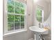 Powder room features a pedestal sink and a window providing natural light at 12905 Bullock Greenway Blvd, Charlotte, NC 28277