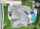 Aerial view of a luxury home showcasing the expansive roofline, lush landscaping, and the resort-style backyard with a pool at 141 Forsythia Ln, Tega Cay, SC 29708