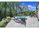 Inviting backyard with pool, lounge chairs, umbrella, and waterfall feature with a tranquil setting at 141 Forsythia Ln, Tega Cay, SC 29708
