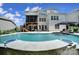 Beautiful backyard with a luxurious pool, lounge seating, screened porch, and lush landscaping at 141 Forsythia Ln, Tega Cay, SC 29708