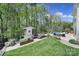Picturesque backyard boasts lush lawn, vegetable garden, playhouse, and inviting swimming pool at 141 Forsythia Ln, Tega Cay, SC 29708