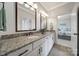Elegant bathroom featuring double sinks, granite countertops, white cabinets, and tiled flooring at 141 Forsythia Ln, Tega Cay, SC 29708