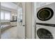 This bathroom features a separate tub and shower with stacked washer and dryer at 141 Forsythia Ln, Tega Cay, SC 29708
