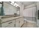 Well-lit bathroom with granite countertops, a large mirror, and white shaker cabinets at 141 Forsythia Ln, Tega Cay, SC 29708