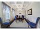 Formal dining room features a beautiful chandelier, coffered ceiling, and elegant decor at 141 Forsythia Ln, Tega Cay, SC 29708